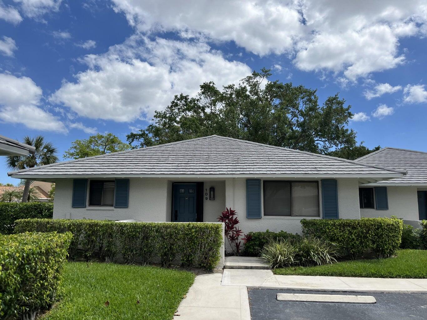 a front view of a house with a garden