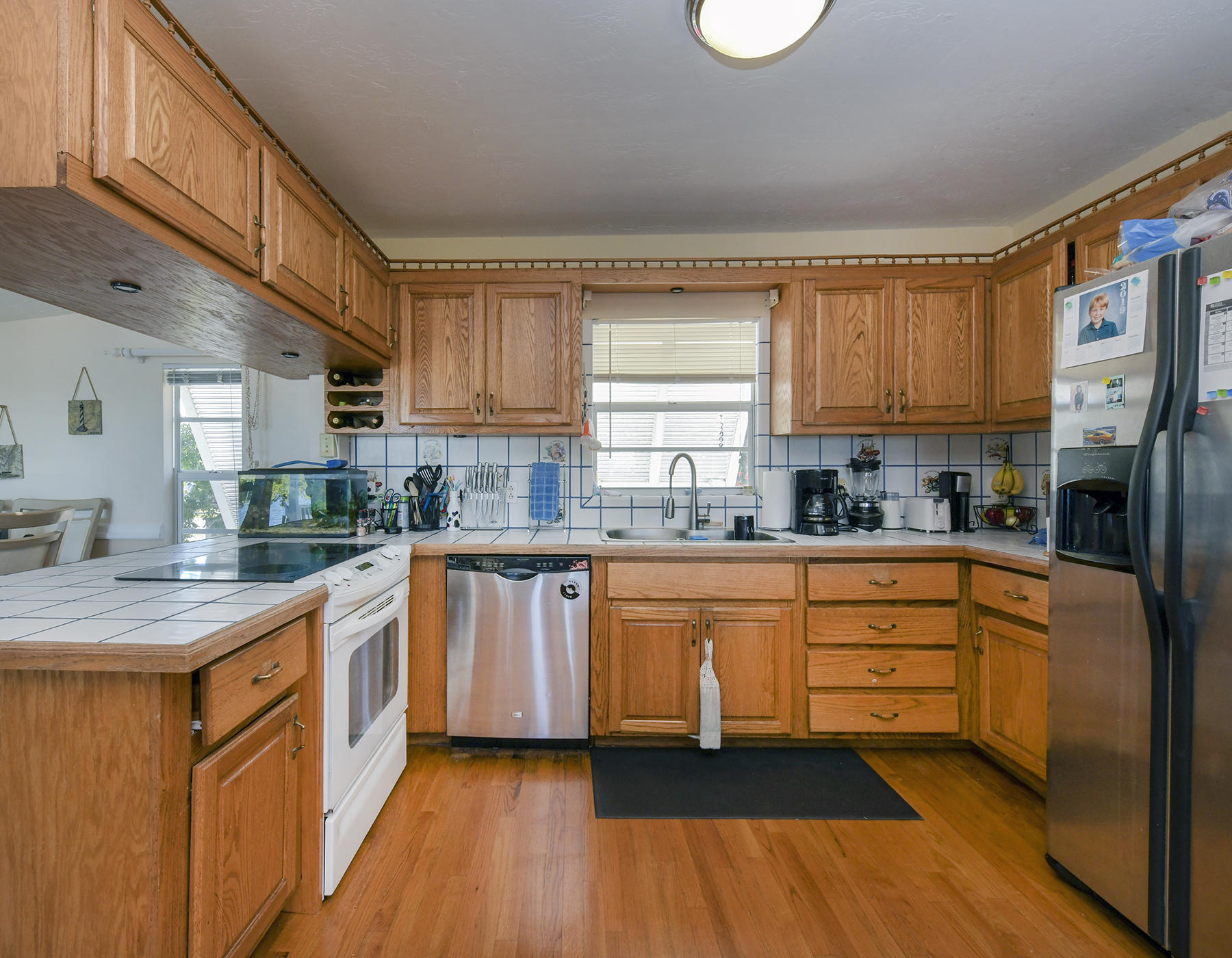 186 Harborview Drive Tavernier, FL 33070 - Photo 11 of 32 a kitchen with stainless steel appliances granite countertop a stove a sink and a refrigerator