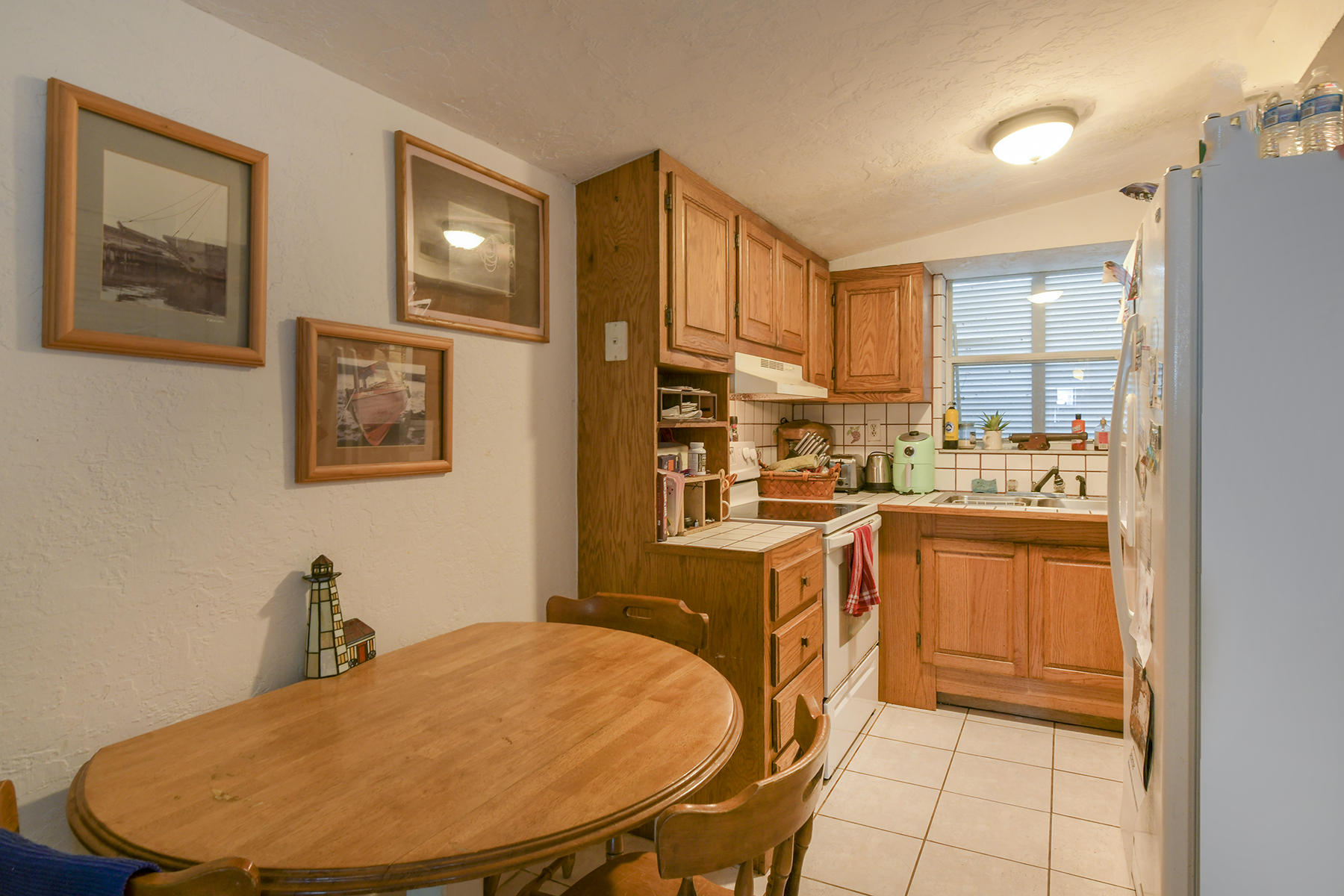 186 Harborview Drive Tavernier, FL 33070 - Photo 20 of 32 a kitchen with stainless steel appliances granite countertop a sink dishwasher and cabinets with wooden floor