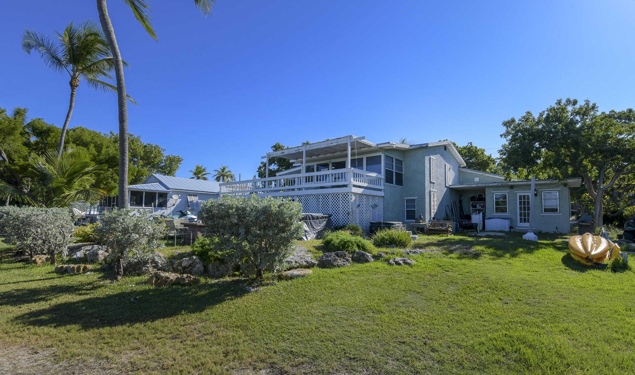 186 Harborview Drive Tavernier, FL 33070 - Photo 2 of 32 a view of a house with backyard sitting area and garden