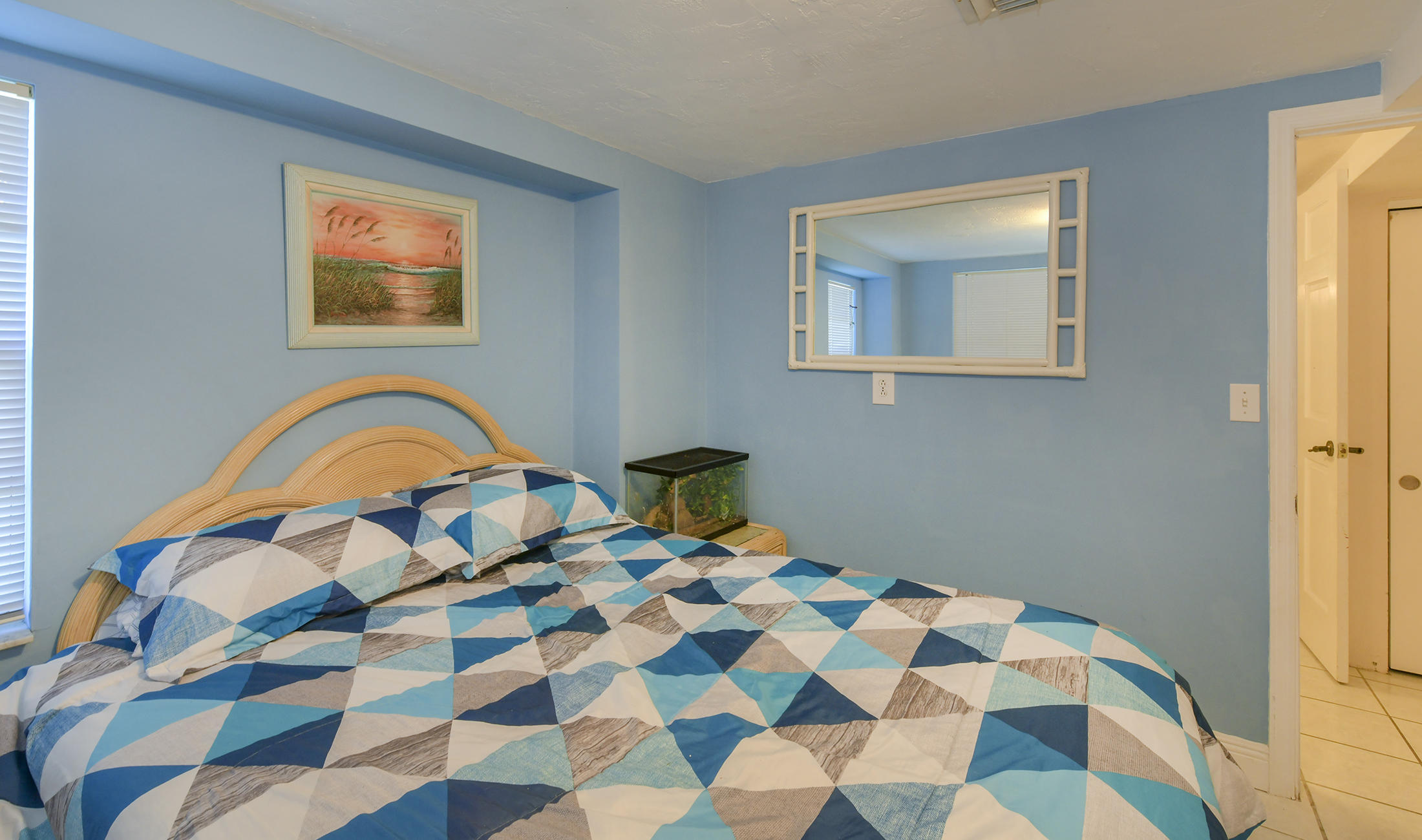 186 Harborview Drive Tavernier, FL 33070 - Photo 23 of 32 a bedroom with a bed and a painting on the wall