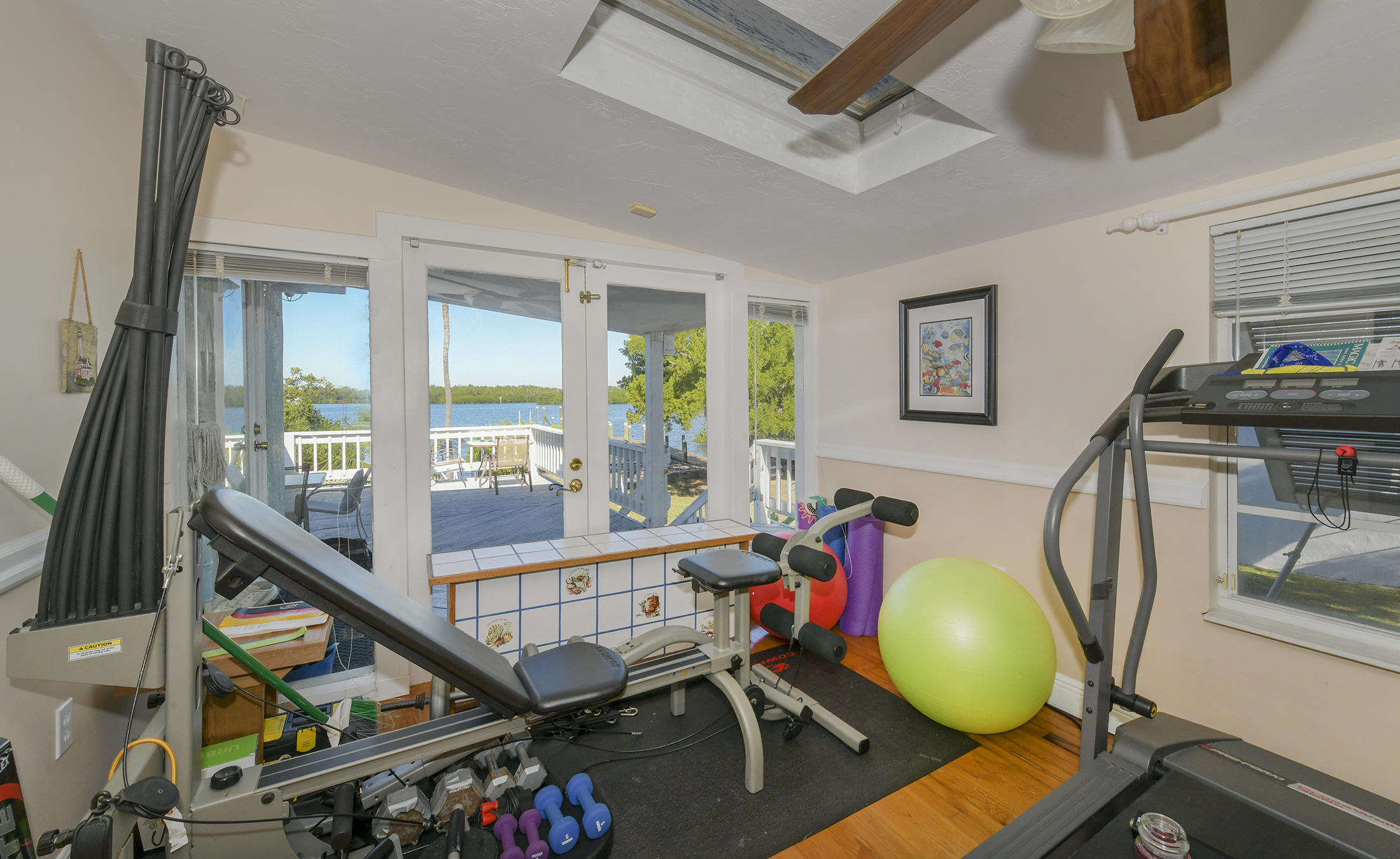 186 Harborview Drive Tavernier, FL 33070 - Photo 27 of 32 a view of a room with wooden floor and windows