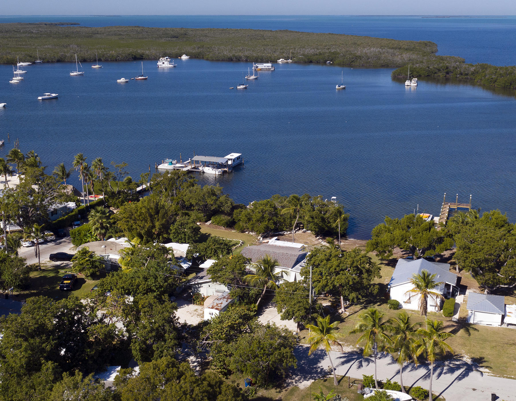 186 Harborview Drive Tavernier, FL 33070 - Photo 30 of 32 a view of a lake with lawn chairs