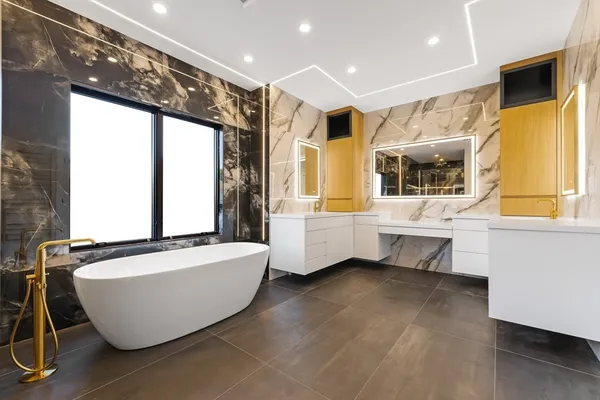 a bathroom with a sink mirror and a bathtub