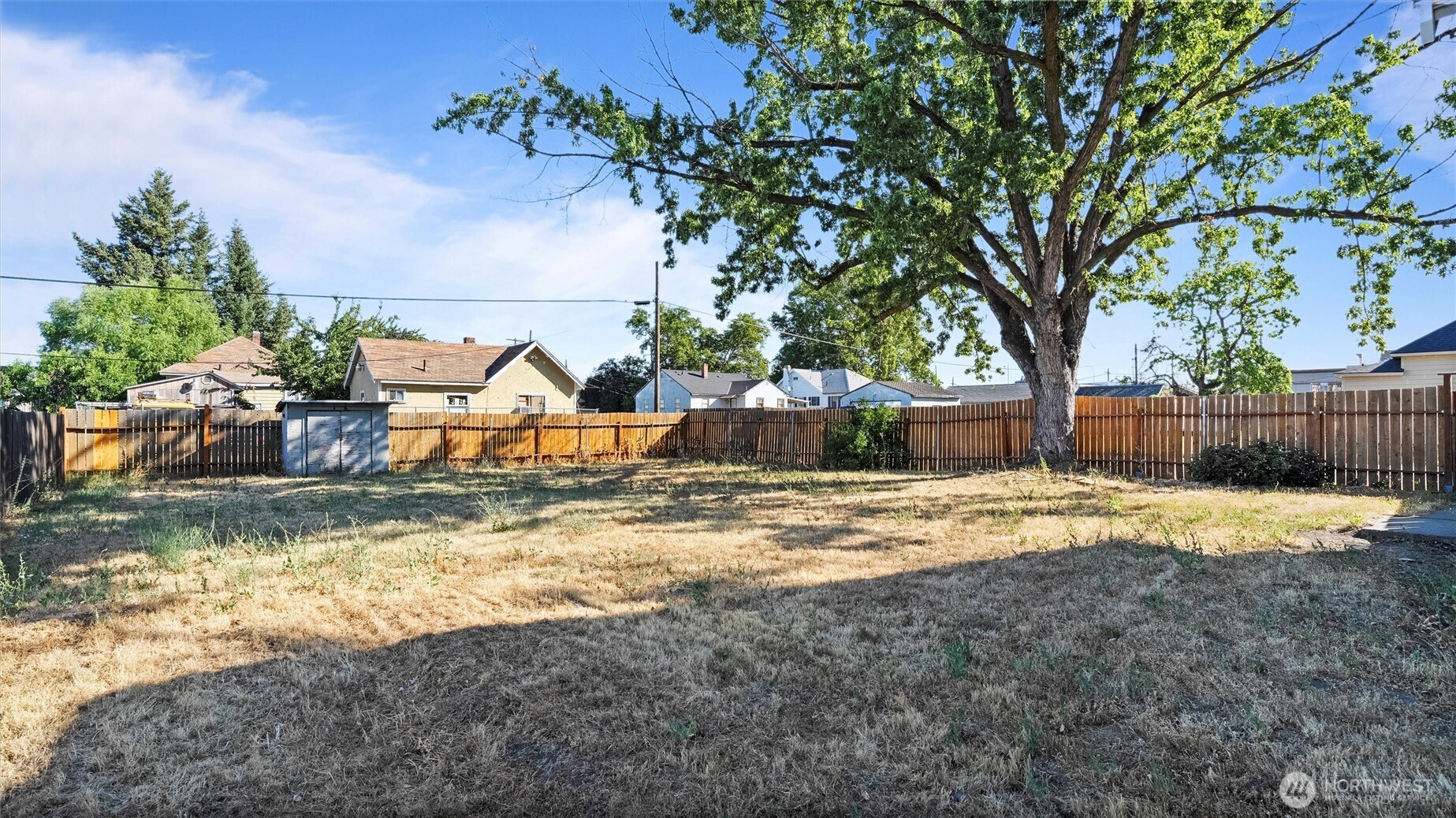 902 Emma Street Walla Walla, WA 99362 - Photo 29 of 29 a view of a backyard with a fountain plants and large tree