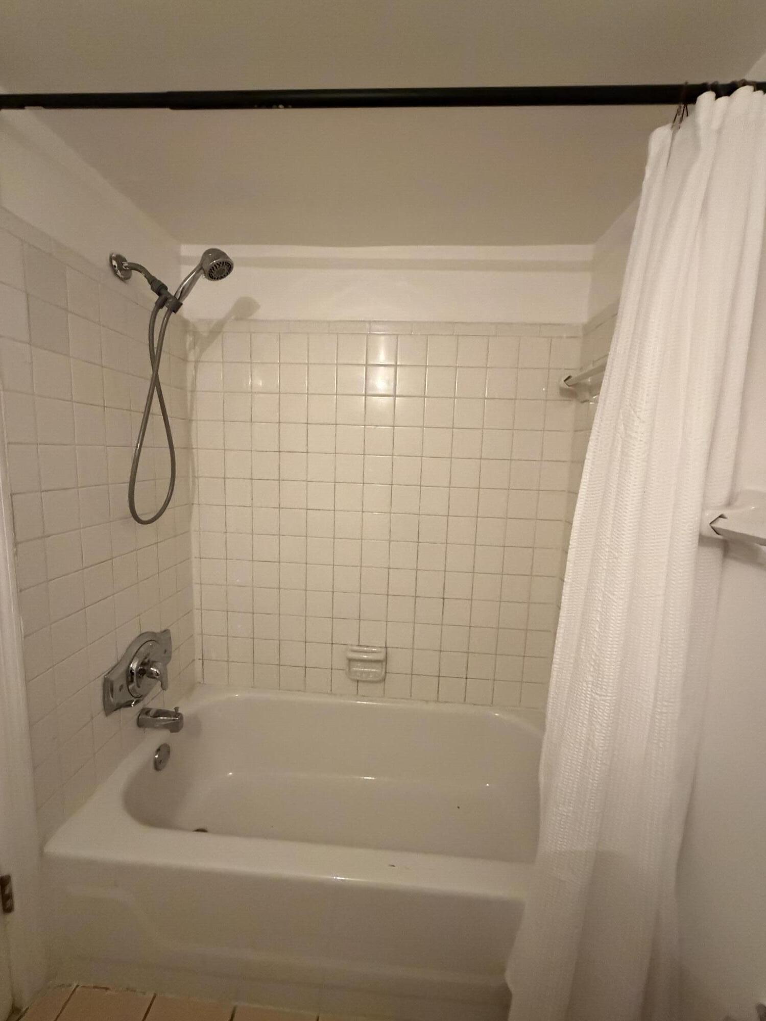 270 South Cypress Road, Unit 204 Pompano Beach, FL 33060 - Photo 10 of 14 a bathroom with a shower and a bath tub