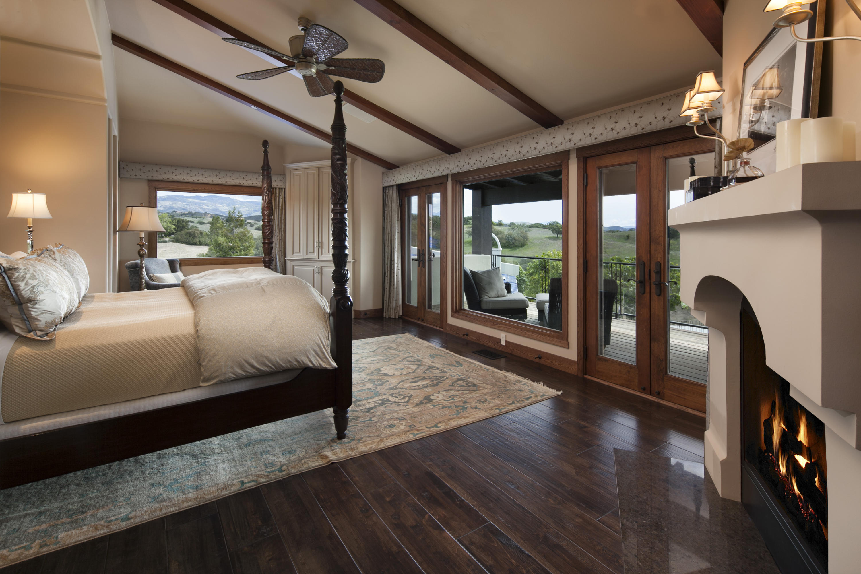 2905 Roundup Road Santa Ynez, CA 93460 - Photo 22 of 34 a bedroom with a large bed wooden floor and window