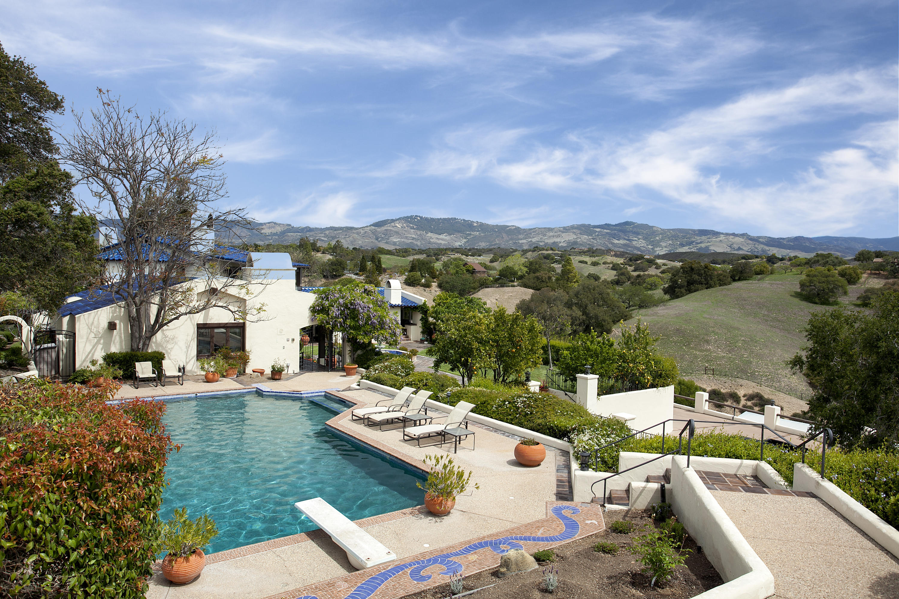 2905 Roundup Road Santa Ynez, CA 93460 - Photo 25 of 34 a view of a patio with couches and table and chairs and potted plants
