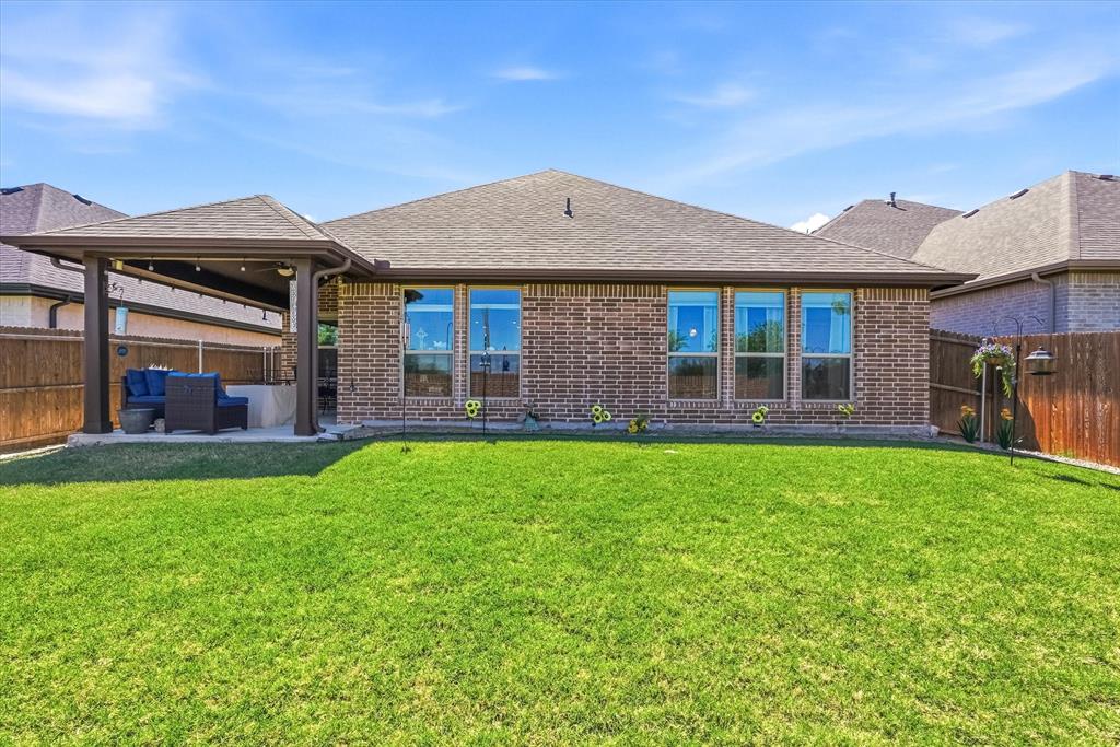813 Mildren Lane Fate, TX 75087 - Photo 22 of 32 The backyard is spacious and the home backs to acreage.