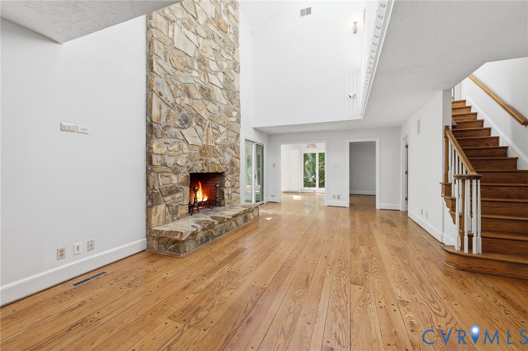 3201 East Brigstock Road Midlothian, VA 23113 - Photo 18 of 72 a view of an empty room with wooden floor fireplace and a window