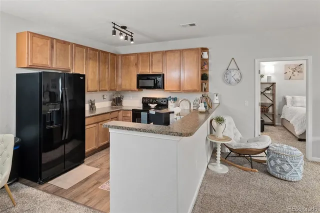 a kitchen with stainless steel appliances a refrigerator a sink a stove a microwave and cabinets