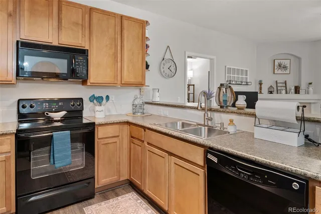 a kitchen with stainless steel appliances granite countertop a sink stove and microwave