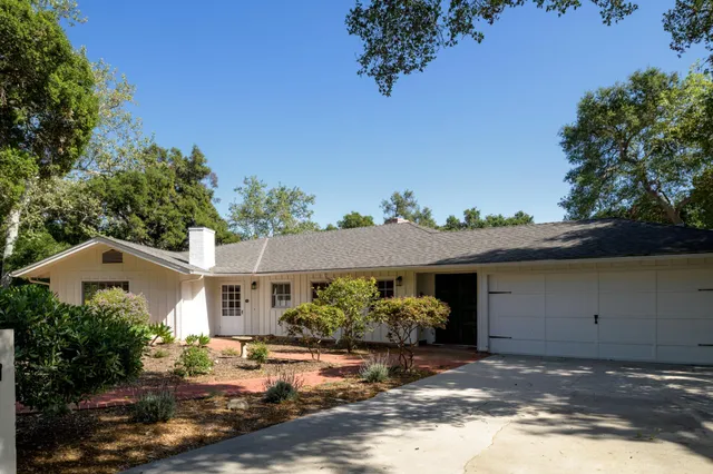 a view of an empty room with a window and fire place