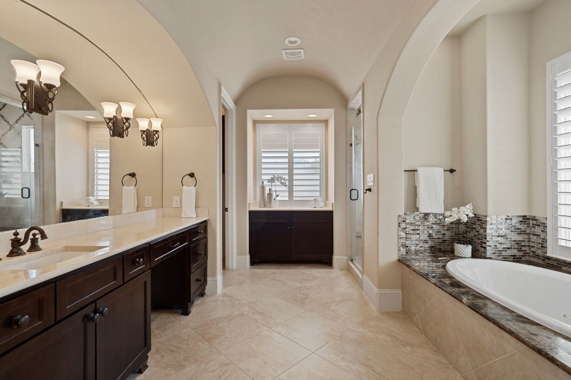 622 Pink Azalea Trail Houston, TX 77079 - Photo 26 of 50 Unwind in the serene primary bath, thoughtfully designed with dual vanities, a dedicated vanity space, soaking tub, expansive walk-in shower, and abundant storage