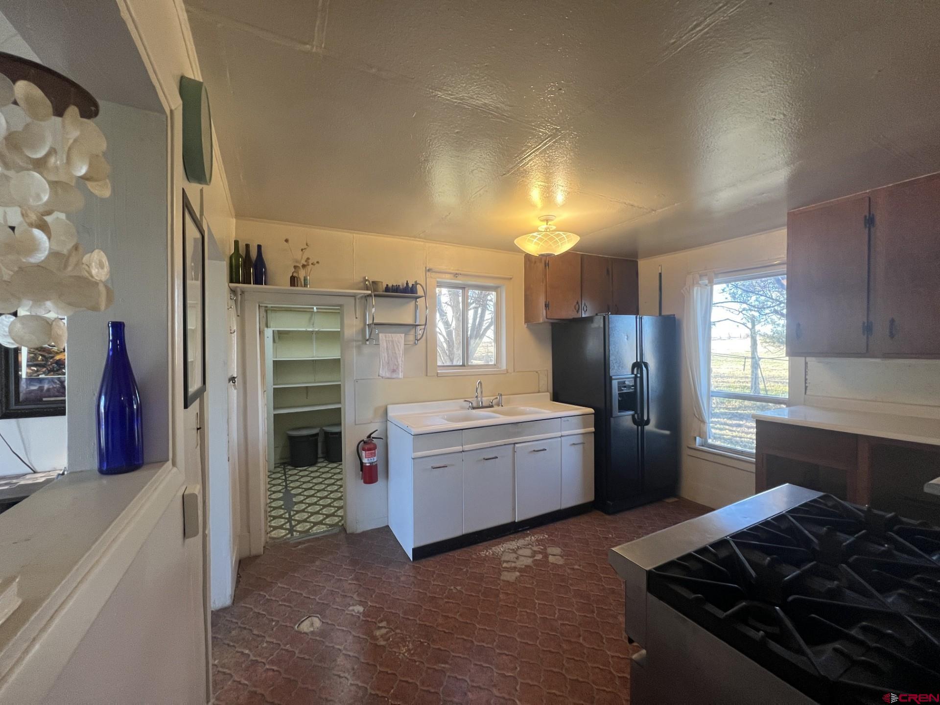 12363 Road 25 Cortez, CO 81321 - Photo 11 of 26 a kitchen with refrigerator and cabinets