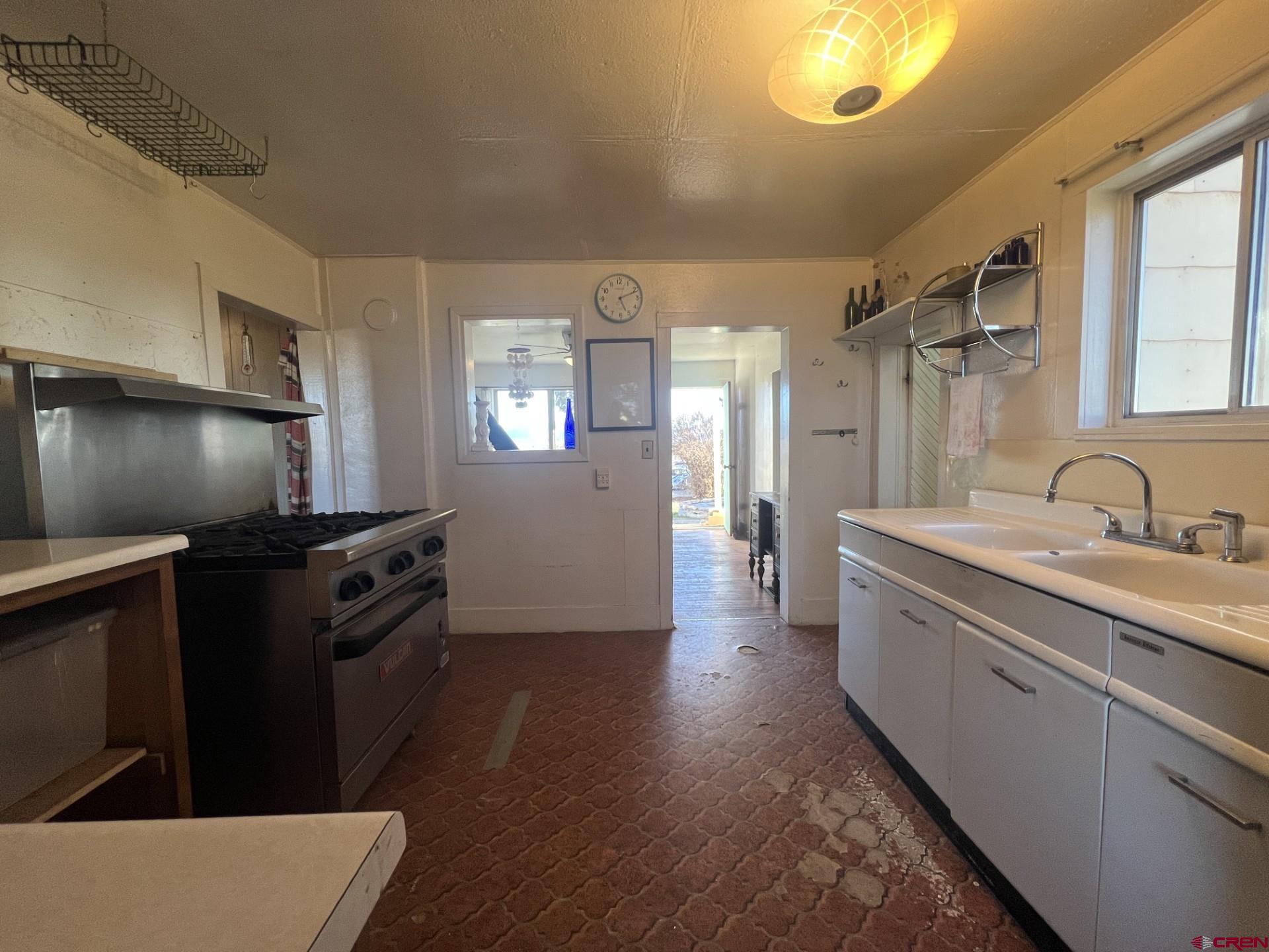 12363 Road 25 Cortez, CO 81321 - Photo 12 of 26 a kitchen with granite countertop a sink stove and refrigerator