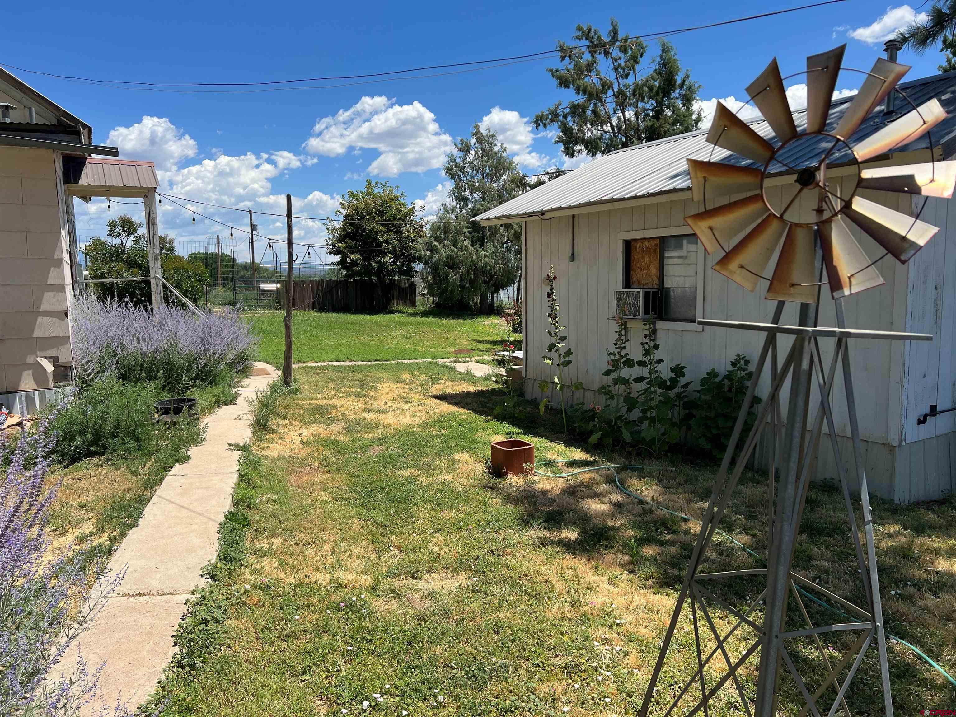 12363 Road 25 Cortez, CO 81321 - Photo 16 of 26 a view of a house with a yard