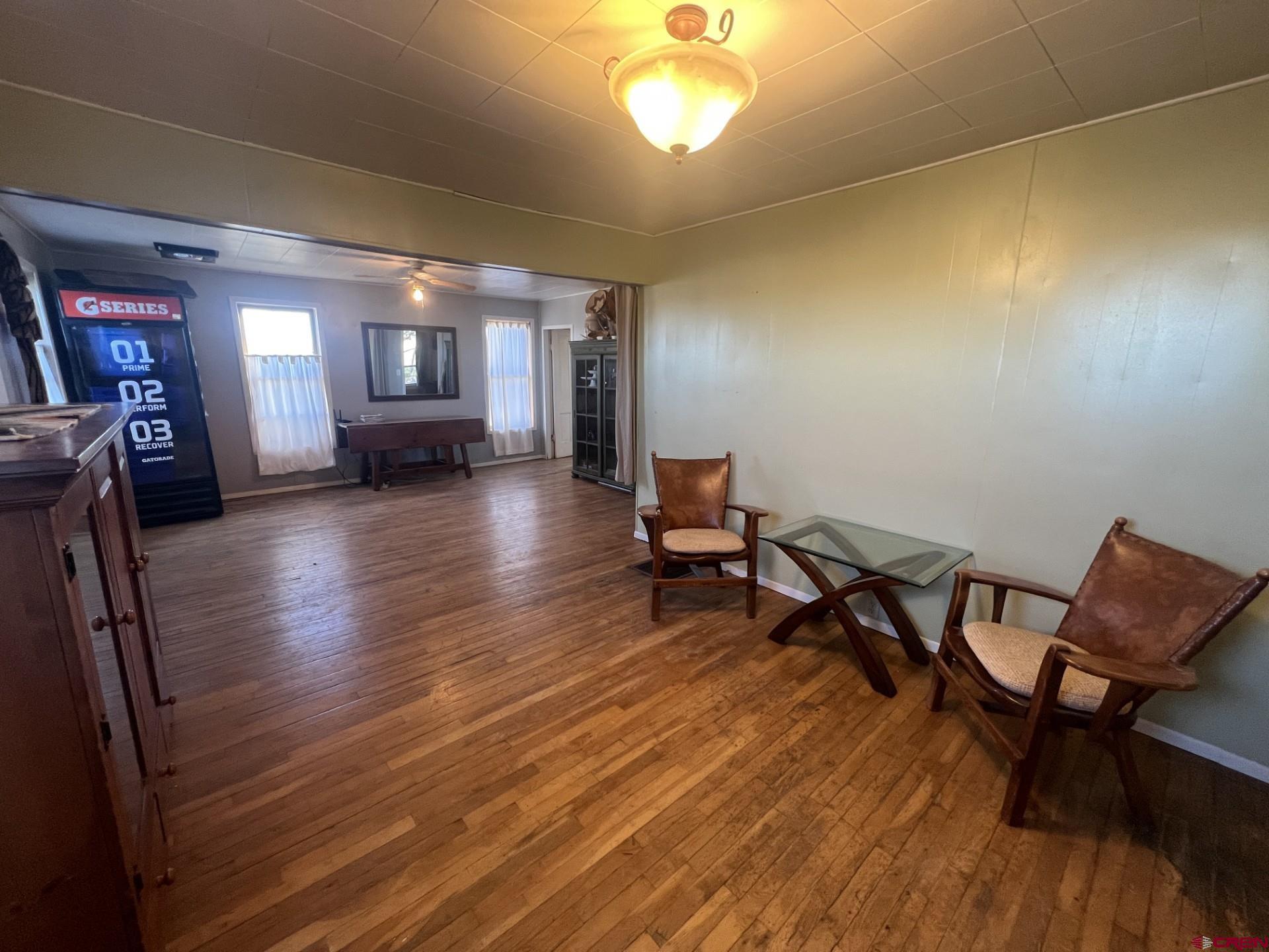 12363 Road 25 Cortez, CO 81321 - Photo 2 of 26 a living room with furniture and a wooden floor