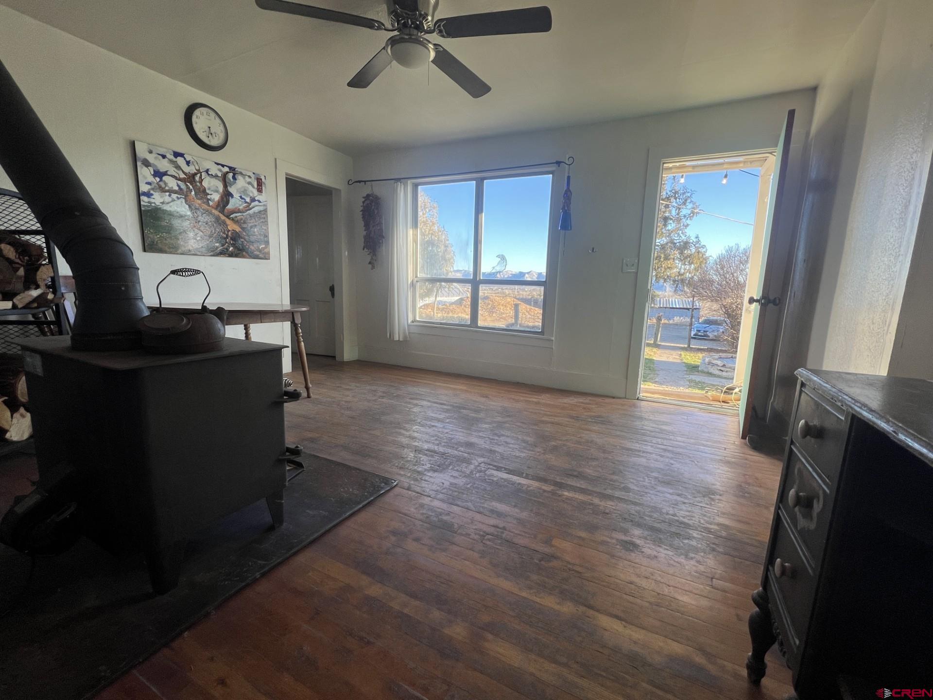 12363 Road 25 Cortez, CO 81321 - Photo 3 of 26 a view of livingroom with hardwood floor and a ceiling fan