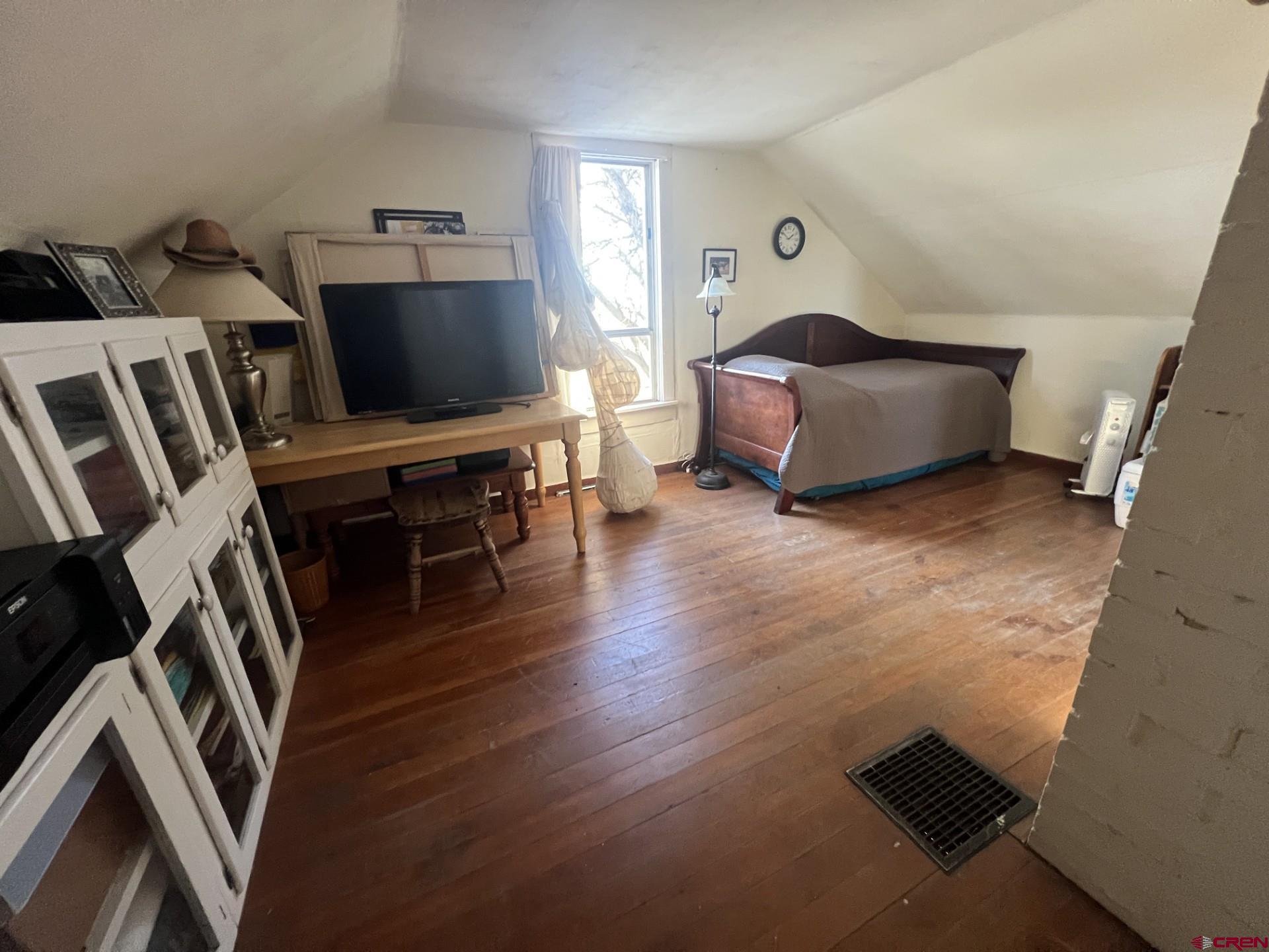 12363 Road 25 Cortez, CO 81321 - Photo 5 of 26 a living room with furniture and a flat screen tv