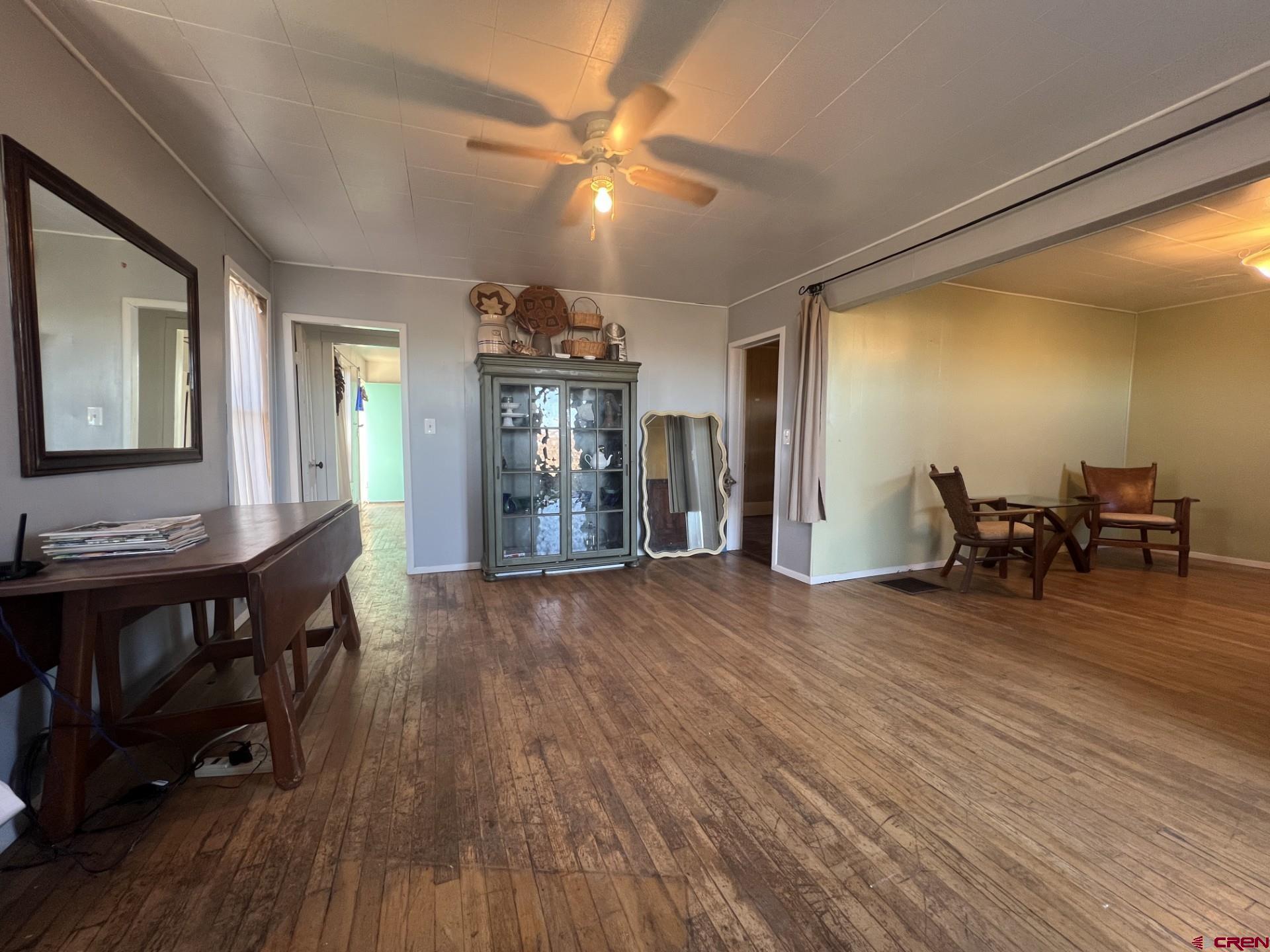 12363 Road 25 Cortez, CO 81321 - Photo 7 of 26 a view of a livingroom with furniture wooden floor and chandelier