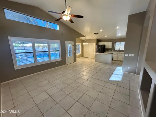 a view of kitchen with windows and refrigerator