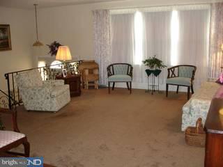 917 Longstreth Road Warminster, PA 18974 - Photo 3 of 6 a living room with furniture and potted plants