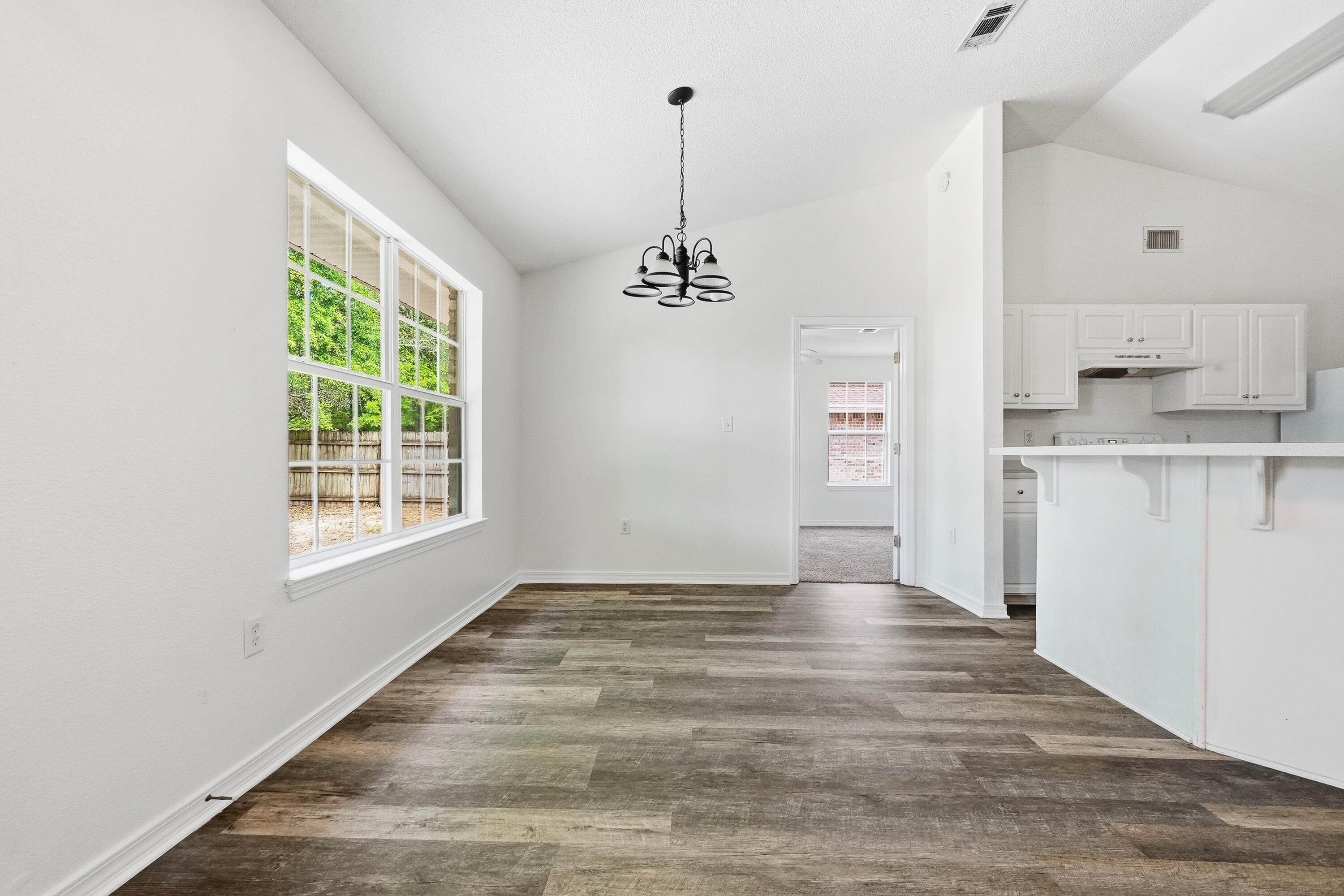 4087 Audiss Road Milton, FL 32583 - Photo 12 of 34 a view of empty room with wooden floor and window