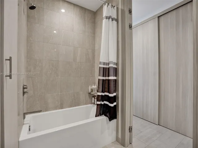 a bathroom with a bathtub and a shower