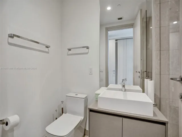 a bathroom with a sink toilet and vanity