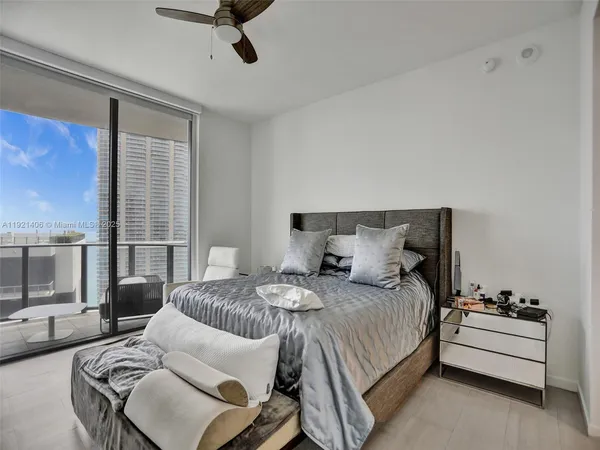 a bedroom with furniture and a window