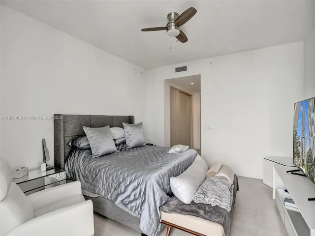 a bedroom with a bed and a television