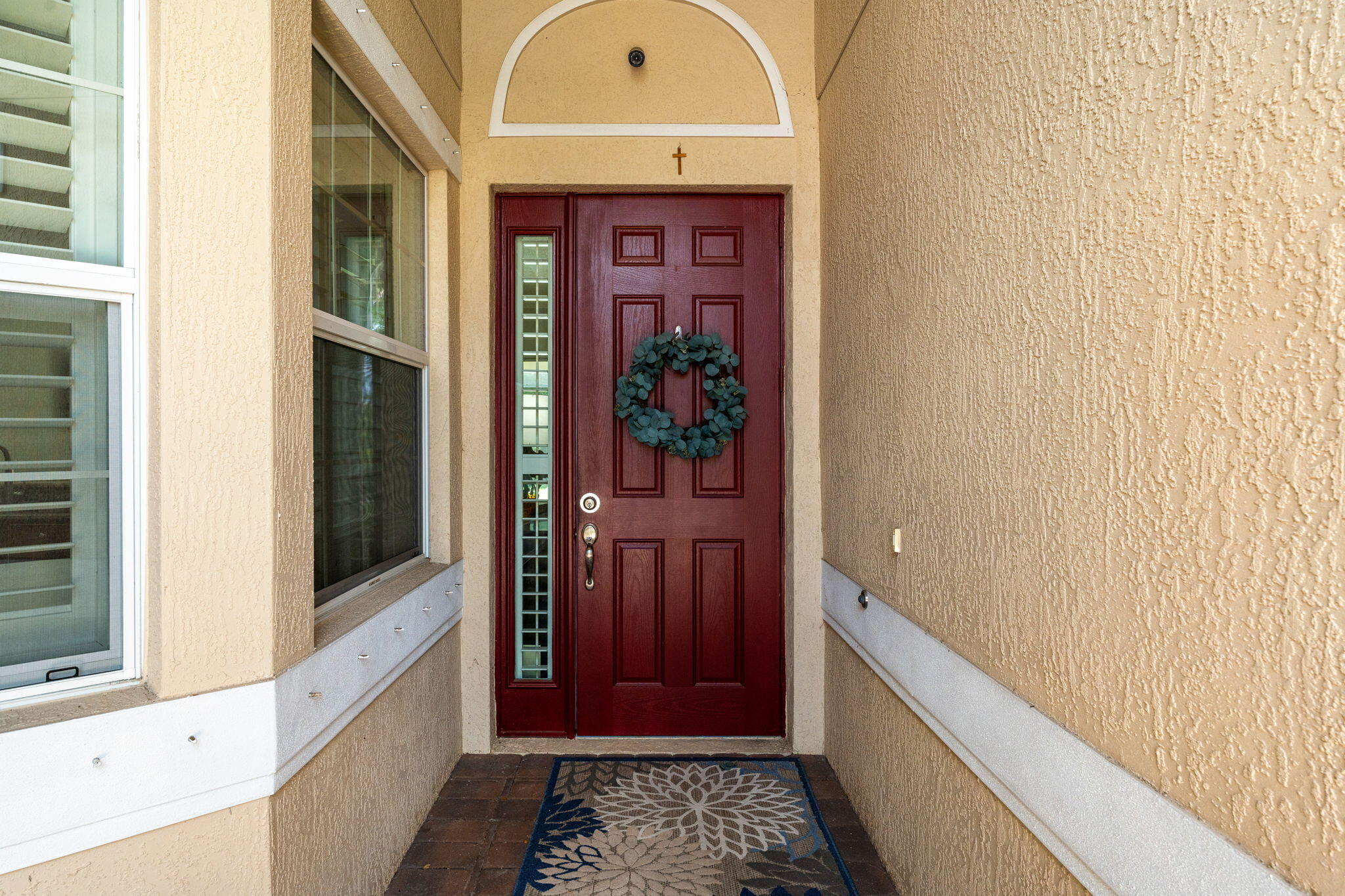 7657 Fieldstone Ranch Square Vero Beach, FL 32967 - Photo 6 of 52 a view of a hallway with wooden floor and a bathroom