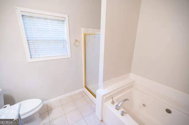 a bathroom with a bathtub and toilet