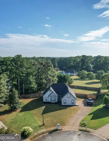 a view of a terrace with a garden and trees