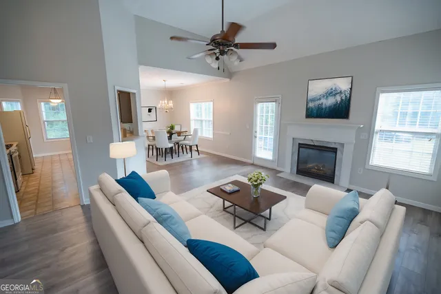a living room with furniture and a fireplace