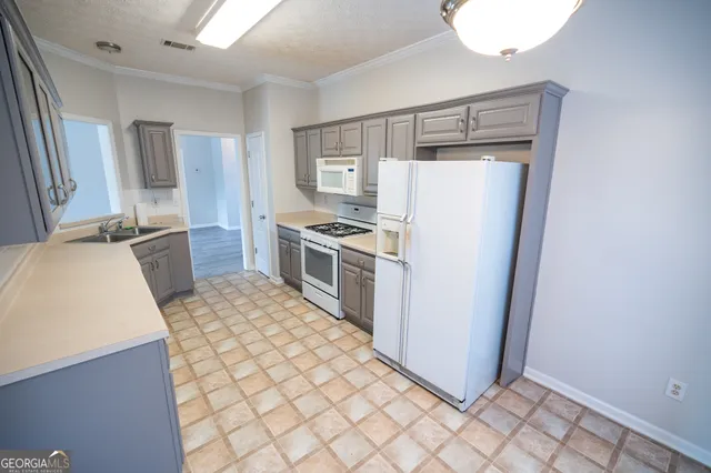 a kitchen with a refrigerator sink and stove