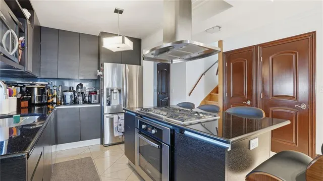 a living room with furniture a flat screen tv and a floor to ceiling window