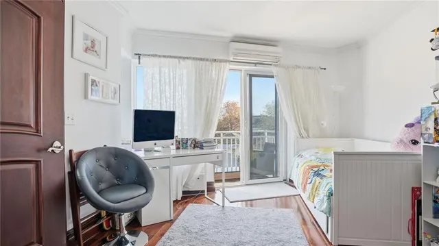 a bed sitting in a room next to a window and chair