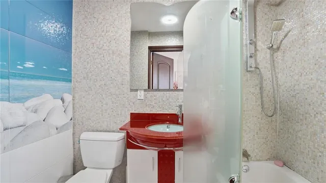 a bathroom with a toilet a sink and bathtub