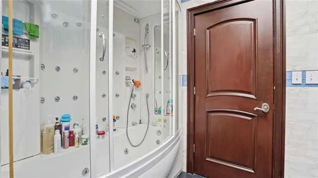 a bathroom with a mirror and a shower