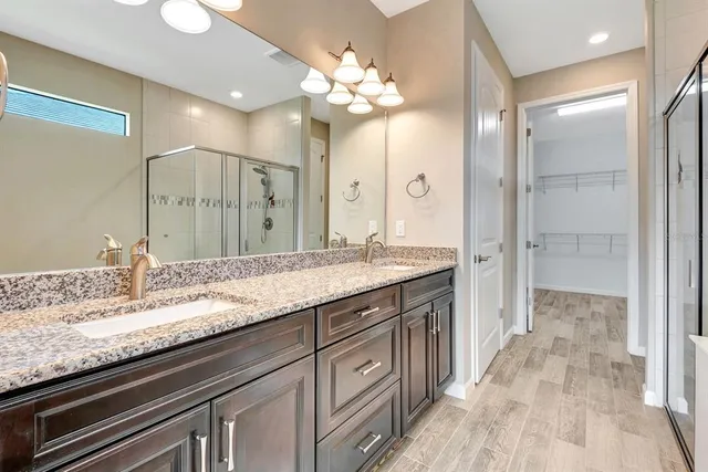 a bathroom with a shower and a mirror