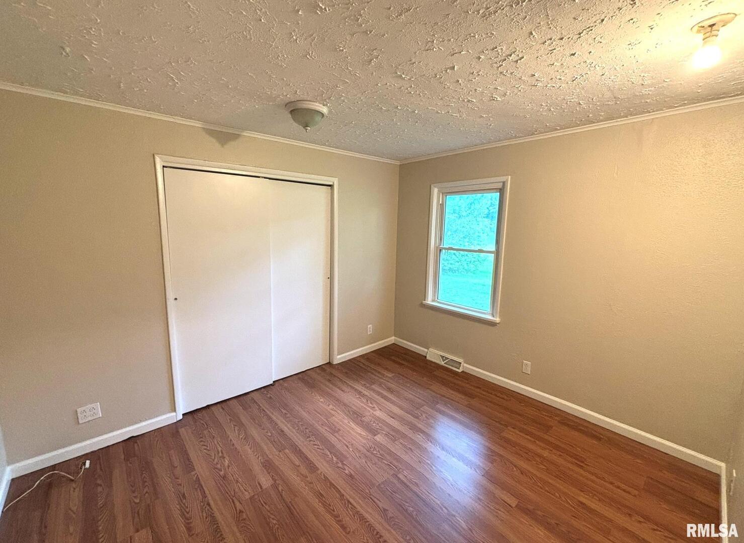 145 Hickory Grove Lane Salem, IL 62881 - Photo 15 of 20 an empty room with wooden floor and windows