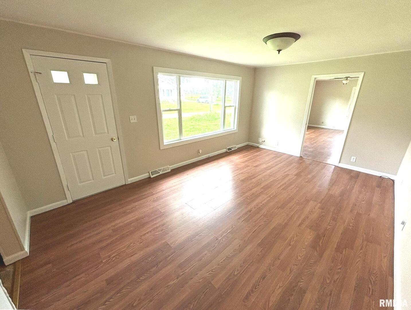145 Hickory Grove Lane Salem, IL 62881 - Photo 2 of 20 an empty room with wooden floor and windows