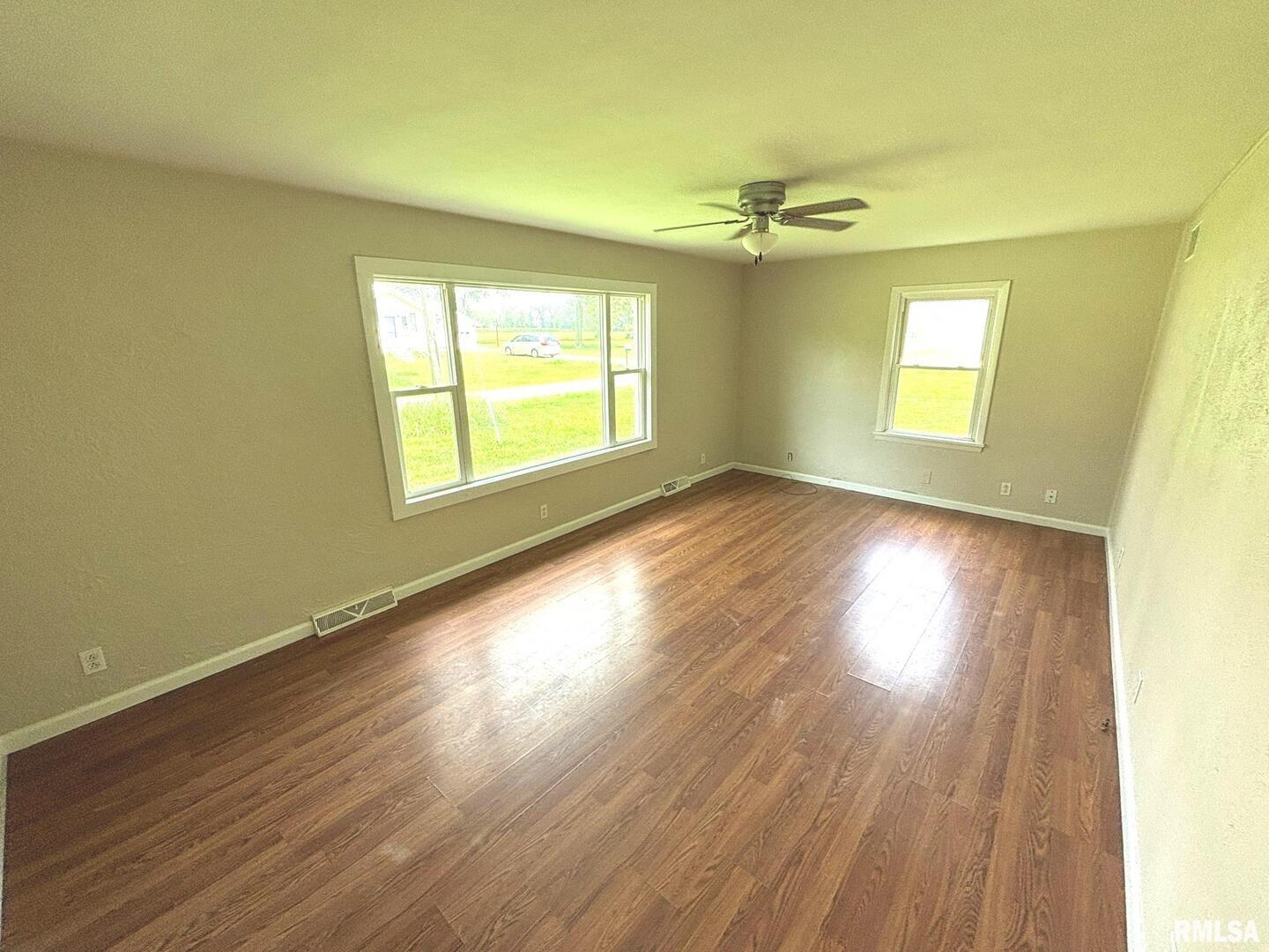 145 Hickory Grove Lane Salem, IL 62881 - Photo 5 of 20 a view of an empty room with wooden floor and a window