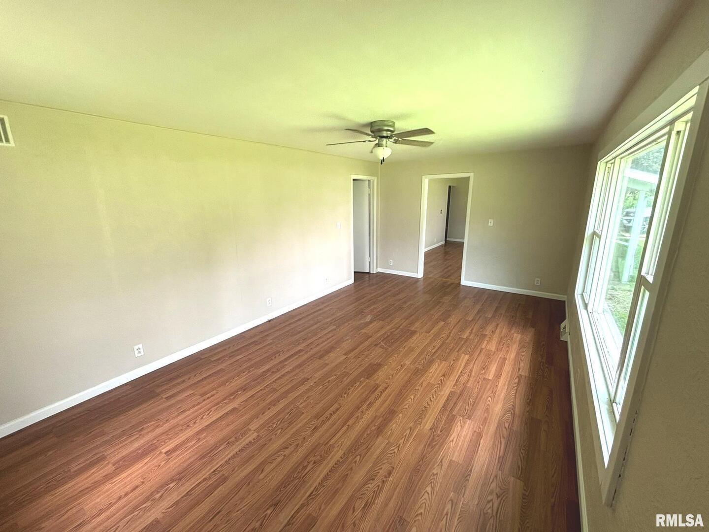 145 Hickory Grove Lane Salem, IL 62881 - Photo 6 of 20 a view of a room with wooden floor and a window