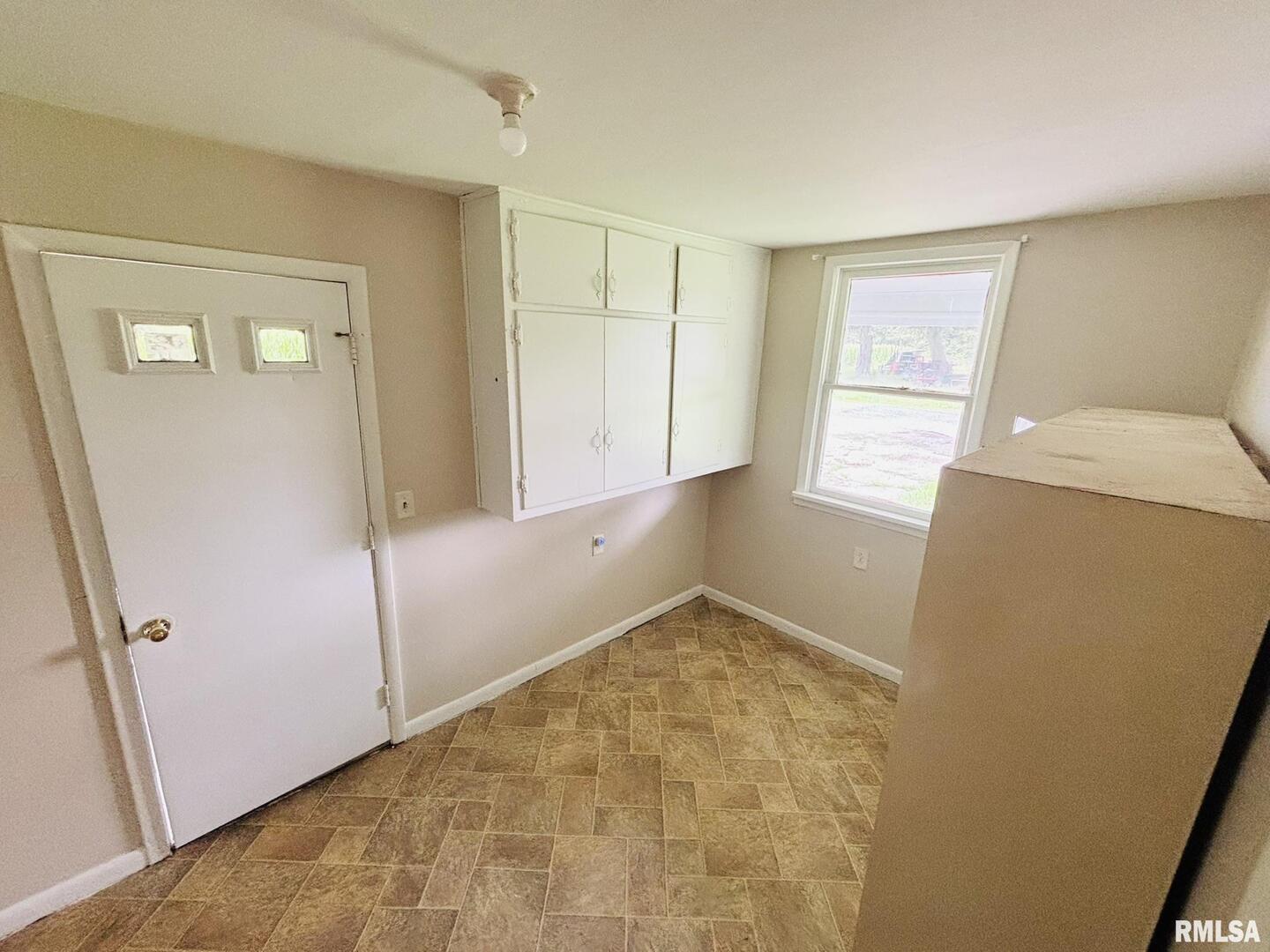 145 Hickory Grove Lane Salem, IL 62881 - Photo 9 of 20 a view of an empty room with window and refrigerator