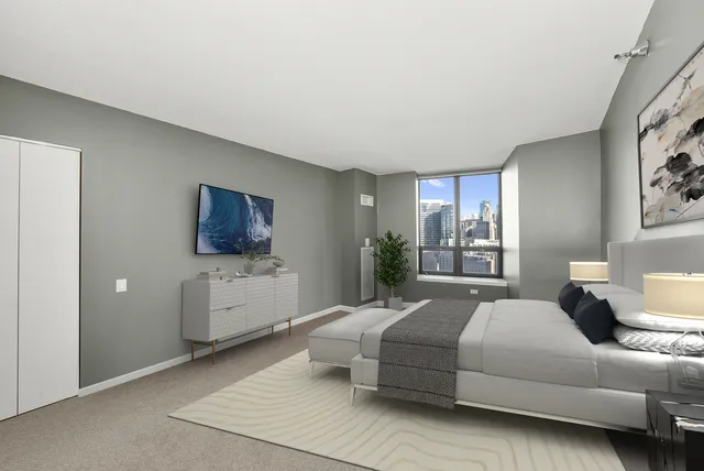 a bedroom with a bed a couch and dresser