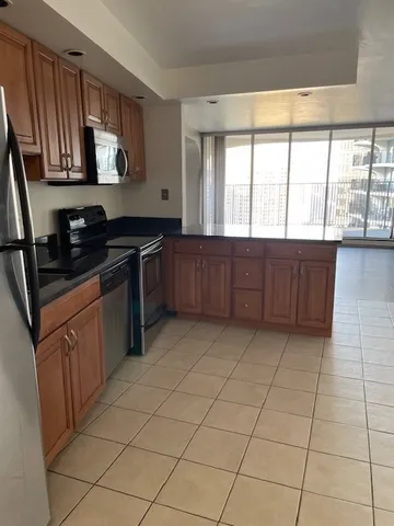 a kitchen with stainless steel appliances granite countertop a stove a sink and a microwave