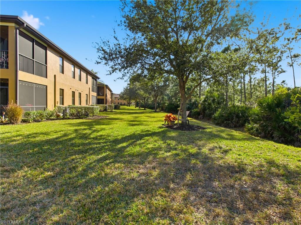 20161 Bravada Street, Unit 2 Estero, FL 33928 - Photo 25 of 33 a garden with trees in front of it